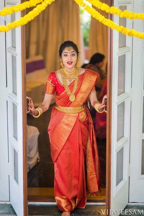 Photo of Bride in a gold and mint green saree with diamond jewellery.