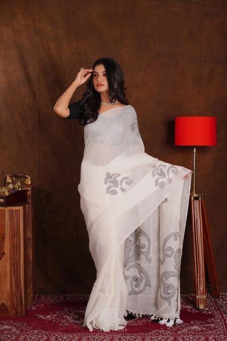 White Linen Saree with all-over yellow buttas, self- pallu & contrast  piping border