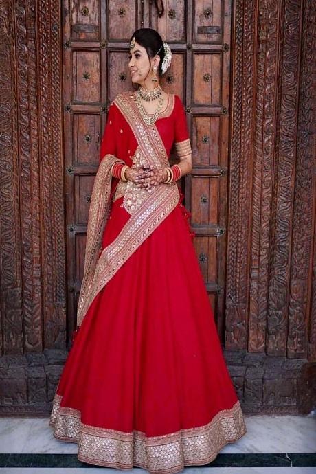 Premium Photo | Indian Teen Girl Capturing Hearts in Timeless Red Gold  Lehenga Dress with Radiant Smile